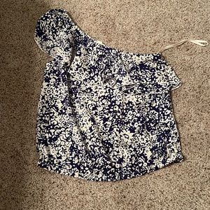 blue flowery shirt that hangs on one shoulder